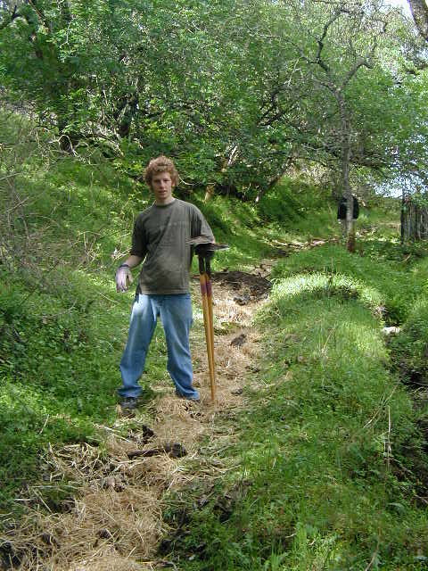 Jonah with rice straw for trail closure