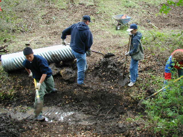 Davis, Randy and Robert clear ditch for the culvert